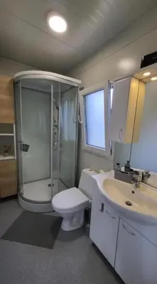 a bathroom with a shower and a toilet and a sink at BIG BERRY KOLPA - KIWI mobile house, Metlika in Gradac