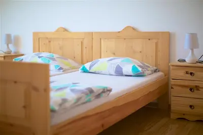 a bedroom with two beds and two night stands at Tourist Farm Apartments Lovrec in Jiršovci