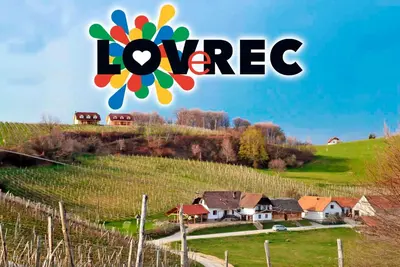 a sign that saysoviore on a hill with houses at Tourist Farm Apartments Lovrec in Jiršovci