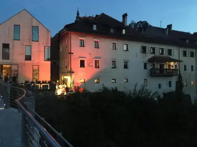 a building with a red light on it at night at Starling Loka in Škofja Loka
