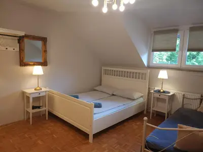 a small bedroom with a bed and two lamps at Avrora House FREE parking in OLD TOWN in Ljubljana