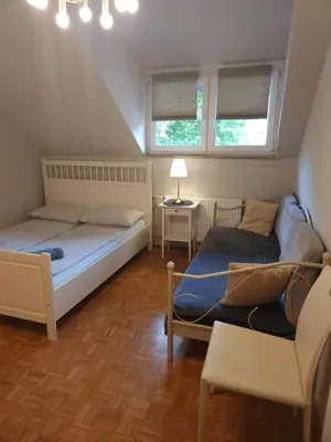 a small bedroom with two beds and a couch at Avrora House FREE parking in OLD TOWN in Ljubljana