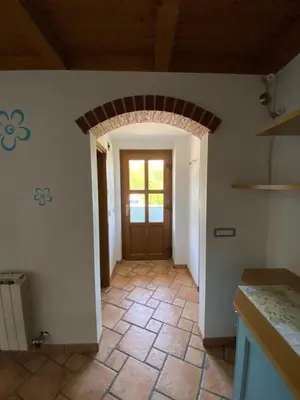 a kitchen with a door and a tile floor at Apartma CASA CELESTE in Renče