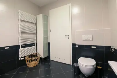 a bathroom with a white toilet and a sink at The Elegant Retreat in Ljubljana