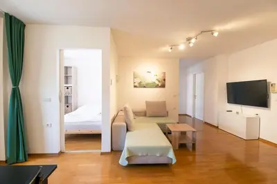 a living room with a couch and a bed at The Elegant Retreat in Ljubljana