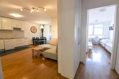 a living room and kitchen with a couch and a table at The Elegant Retreat in Ljubljana