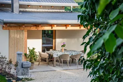 a table and chairs on a patio with a house at Wellness Počitniška hiša Manja in Ljutomer