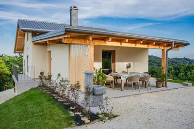 a house with a table and chairs on a patio at Wellness Počitniška hiša Manja in Ljutomer