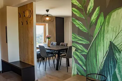 a dining room with a table and a painting on the wall at Wellness Počitniška hiša Manja in Ljutomer