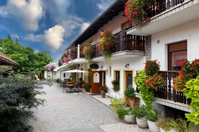 a courtyard of a building with flowers and plants at Tourist farm Pri Andrejevih in Narin