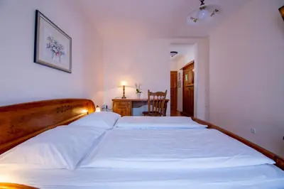 a bedroom with a large bed and a desk at Tourist farm Pri Andrejevih in Narin