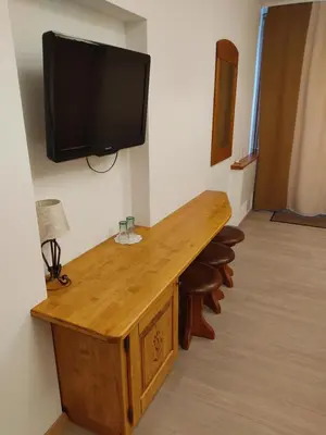 a room with a desk and a tv on a wall at Tourist farm Pri Andrejevih in Narin