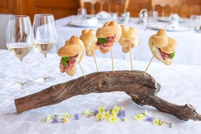 a group of sandwiches on a wooden stick on a table at Tourist farm Pri Andrejevih in Narin