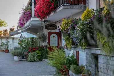 a building with flowers on the side of it at Tourist farm Pri Andrejevih in Narin