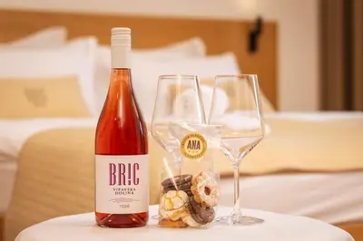 a bottle of wine and two glasses on a table at BRIC Wine & Relax in Vogrsko