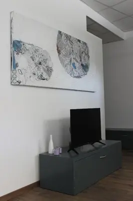 a living room with a television on a cabinet at apartma pika in Šempeter pri Gorici