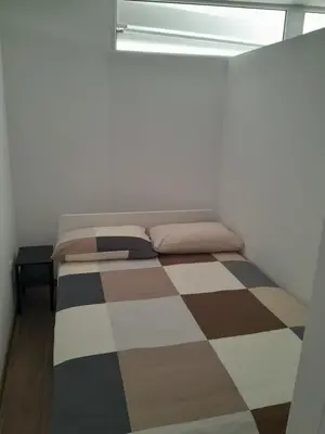 a bed in a room with a checkered floor at apartma pika in Šempeter pri Gorici