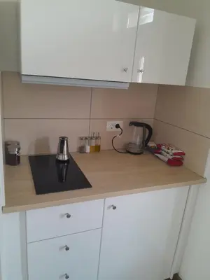 a kitchen with white cabinets and a counter top at apartma pika in Šempeter pri Gorici