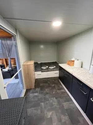 a small kitchen with a stove in a room at Mobile home T&N - Camp Velenje in Velenje