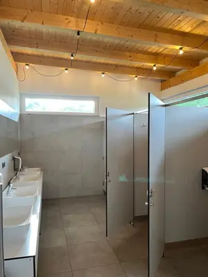a bathroom with two sinks and two toilets at Mobile home T&N - Camp Velenje in Velenje
