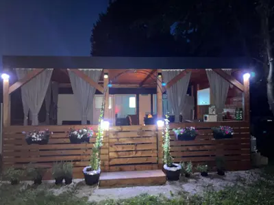 a gazebo at night with lights and plants at Mobile home T&N - Camp Velenje in Velenje
