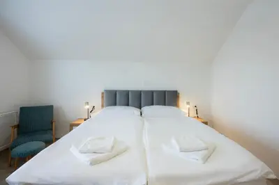 a bedroom with a large bed with two pillows at Apartment Erika in Bled