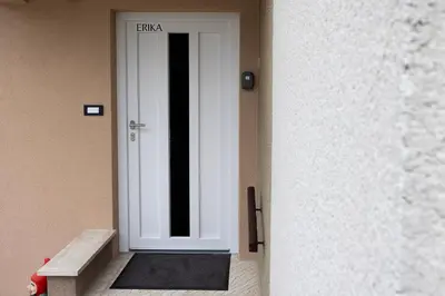 a white door with a bench in front of it at Apartment Erika in Bled