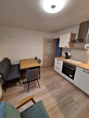 a kitchen and living room with a table and a dining room at Apartment Erika in Bled