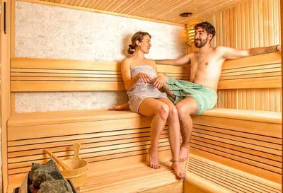 a man and a woman sitting in a sauna at Villa Loren in Avber