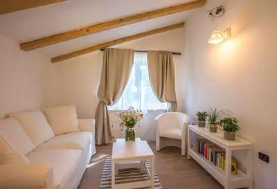 a living room with a white couch and a table at Villa Loren in Avber