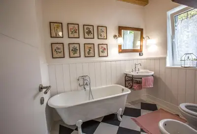a bathroom with a tub and a toilet and a sink at Villa Loren in Avber