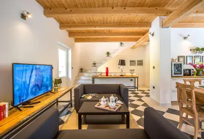 a living room with a couch and a tv at Villa Loren in Avber