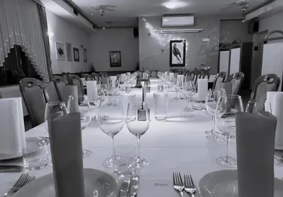 a long table with empty wine glasses on it at Apartments at Gostilna Martin in Trbovlje