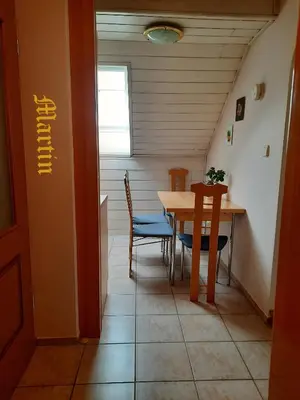 a dining room with a table and chairs in a room at Apartments at Gostilna Martin in Trbovlje