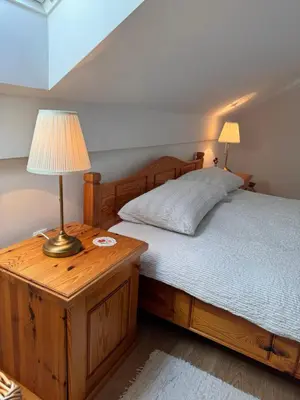 a bedroom with a bed with a lamp on a wooden table at Holiday home Ana in Fokovci