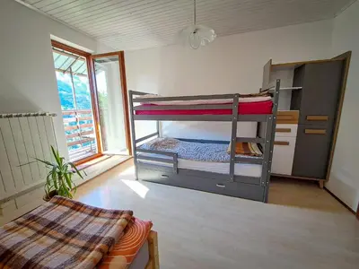 a room with two bunk beds in a room at Hikers Hut Hišar in Podbrdo
