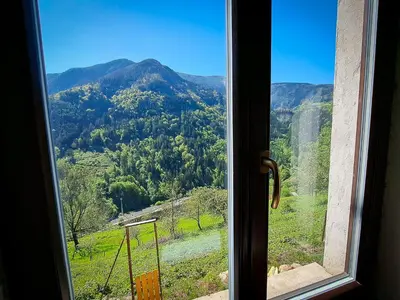 a window with a view of a mountain at Hikers Hut Hišar in Podbrdo