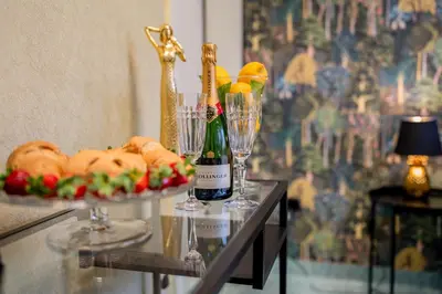 a glass table with two glasses and a plate of food at Diamond dream in Ptuj
