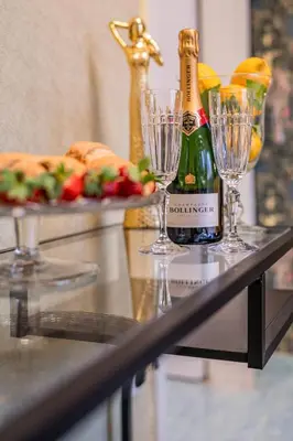 a bottle of champagne and two glasses on a table at Diamond dream in Ptuj