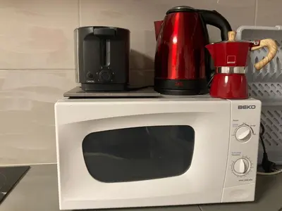 a red appliance sitting on top of a microwave at Boutique Apartments in Ljubljana