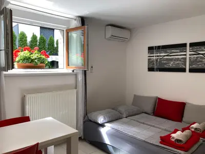 a living room with a couch and a window at Boutique Apartments in Ljubljana