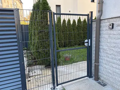 a gate to a garden with a hedge at Boutique Apartments in Ljubljana
