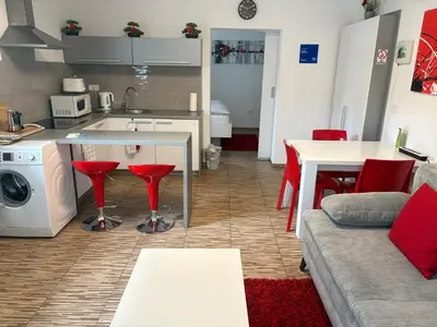 a kitchen and living room with a couch and a table at Boutique Apartments in Ljubljana