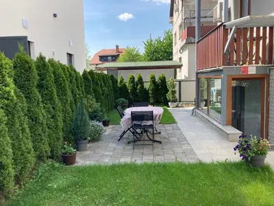 a patio with a table in the middle of a yard at Boutique Apartments in Ljubljana