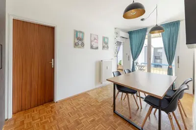 a kitchen and dining room with a table and chairs at Cosy and Bright Apartment in Ljubljana
