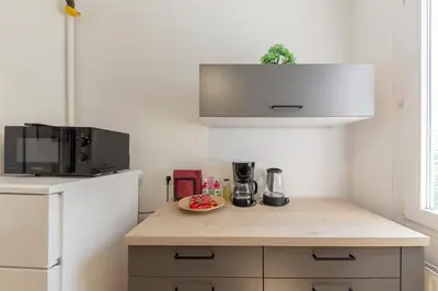 a kitchen with a counter with a bowl of fruit on it at Cosy and Bright Apartment in Ljubljana