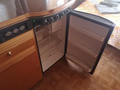 a refrigerator with its door open in a kitchen at Počitniška prikolica Zeleni raj in Podnart