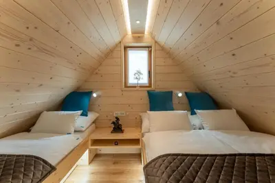 a room with two beds in a tiny house at Luxury Chalet & Sauna Kati - Velika Planina - I Feel Alps in Stahovica