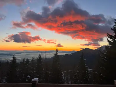a sunset in the mountains with trees and clouds at Luxury Chalet & Sauna Kati - Velika Planina - I Feel Alps in Stahovica