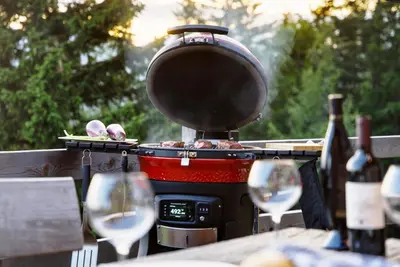a grill with a pot and some wine glasses at Luxury Chalet & Sauna Kati - Velika Planina - I Feel Alps in Stahovica